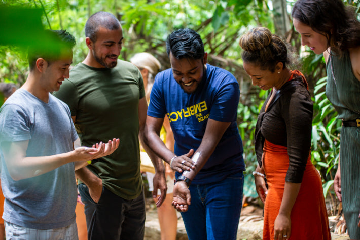 Group learning about local herbs from Sri Lankan guide. Explore Sri Lanka - Land & Sea Tour Options includes educational cultural experiences.