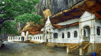 Historic white cave temple built into rock face, featured on the 12-day Sri Lanka tour of spice gardens and cultural sites.