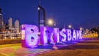 Brisbane sign lit up at night, final destination on East Coast Australia tour. City landmark on 8-day Sydney to Brisbane journey.