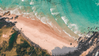 Aerial view of secluded beach on East Coast Australia tour. Coastal beauty on 8-day journey from Sydney to Brisbane.