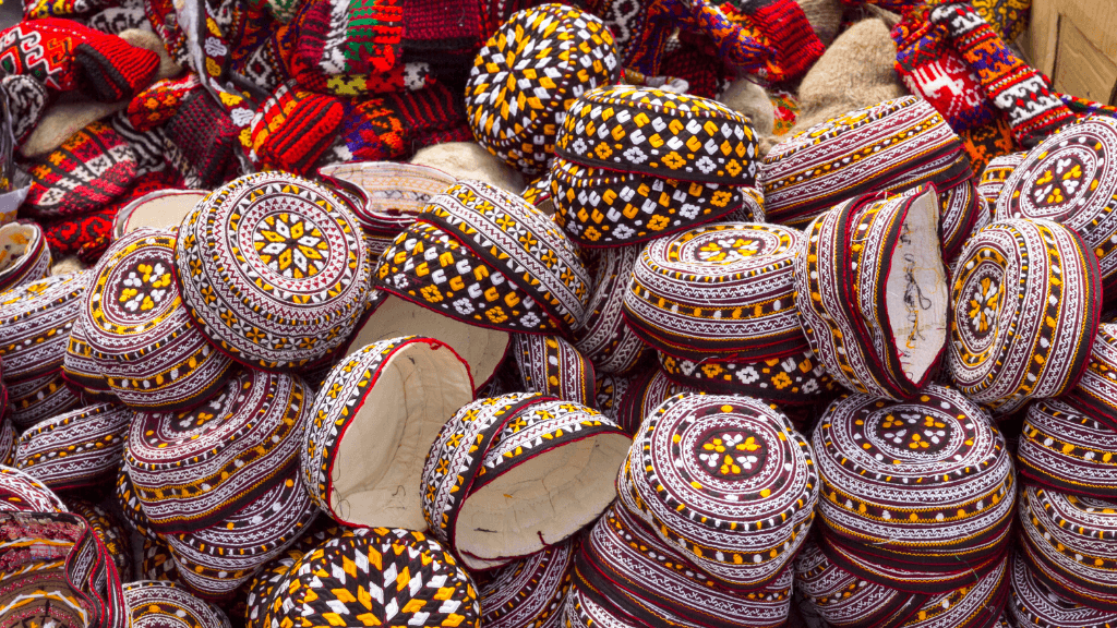 Traditional embroidered caps at a Central Asian market, showcasing local crafts on the Silk Road Cities Tour - Central Asia Adventure.