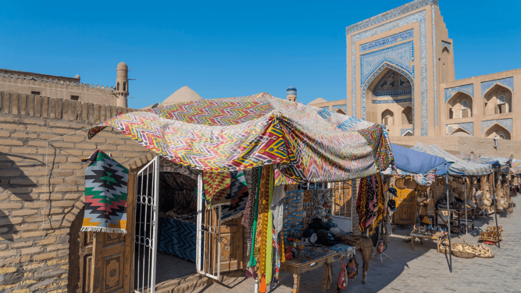 Colorful textile market in Khiva, Uzbekistan, offering local crafts on the Silk Road Cities Tour - Central Asia Adventure.