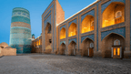 Khiva’s iconic Kalta Minor Minaret and madrasa at dusk, a historic site on the Silk Road Cities Tour - Central Asia Adventure.
