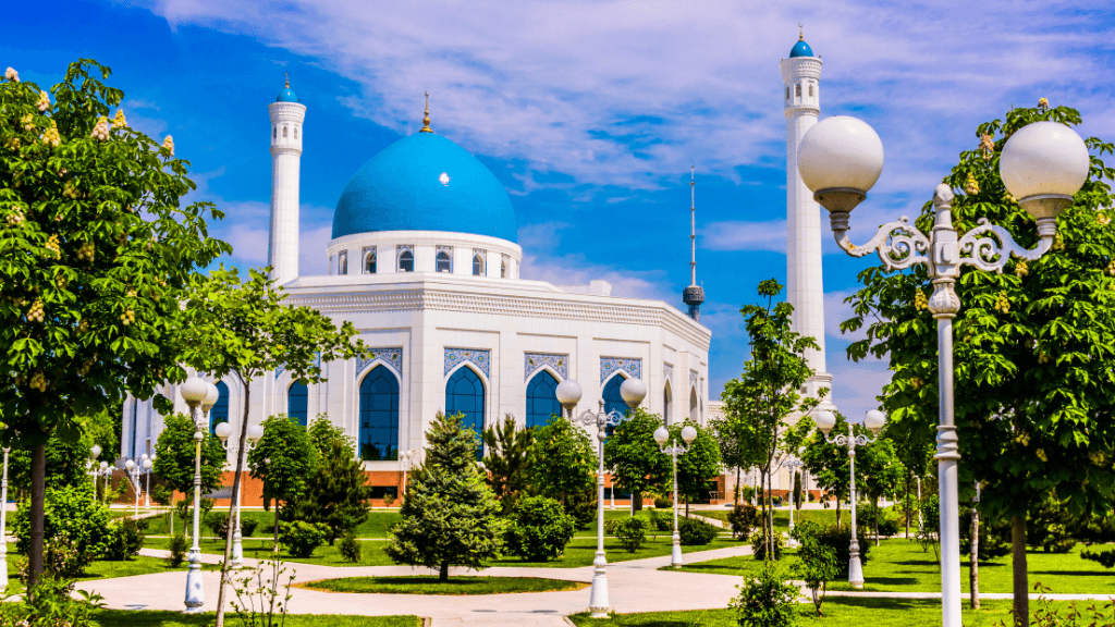 Blue-domed mosque in Tashkent, Uzbekistan, surrounded by gardens, part of the Silk Road Cities Tour - Central Asia Adventure experience.