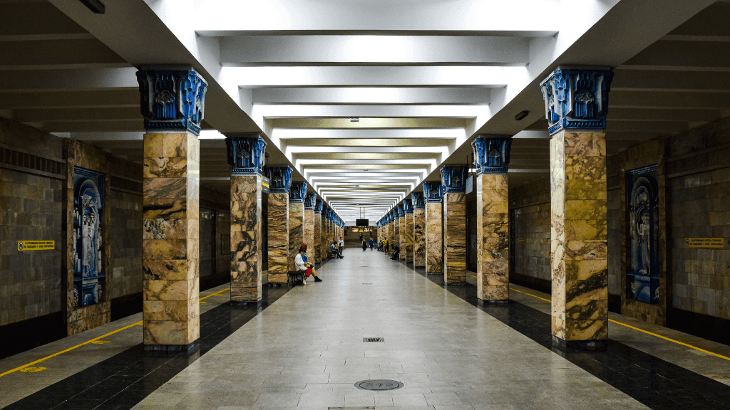 Elegant interior of Tashkent Metro with marble columns, a unique stop on the Silk Road Cities Tour - Central Asia Adventure.