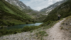 Solo hiker on a trail in the Fann Mountains, Tajikistan, enjoying nature on the Silk Road Cities Tour - Central Asia Adventure.