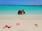 Group of women posing on white sand beach after snorkeling on the Ningaloo Safari 3-Day Kayak & Snorkel Tour.
