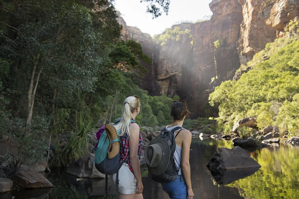 Two hikers exploring a breathtaking outdoor landscape in Kakadu National Park, highlighting adventure and nature.