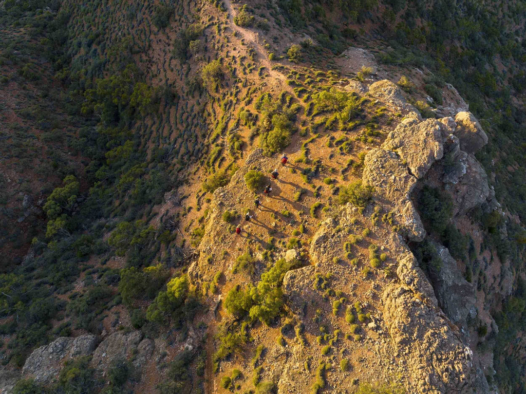 Aerial view of hikers on a rugged trail in the Cape Range, showcasing a stunning outdoor adventure.