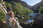 Couple enjoying a scenic view of hidden swimming holes in Australia's Kakadu National Park during their adventure.
