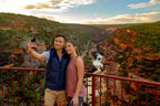 Couple taking selfie at Kalbarri Gorge lookout on West Coast Road Trip. Scenic hiking destination in Western Australia.