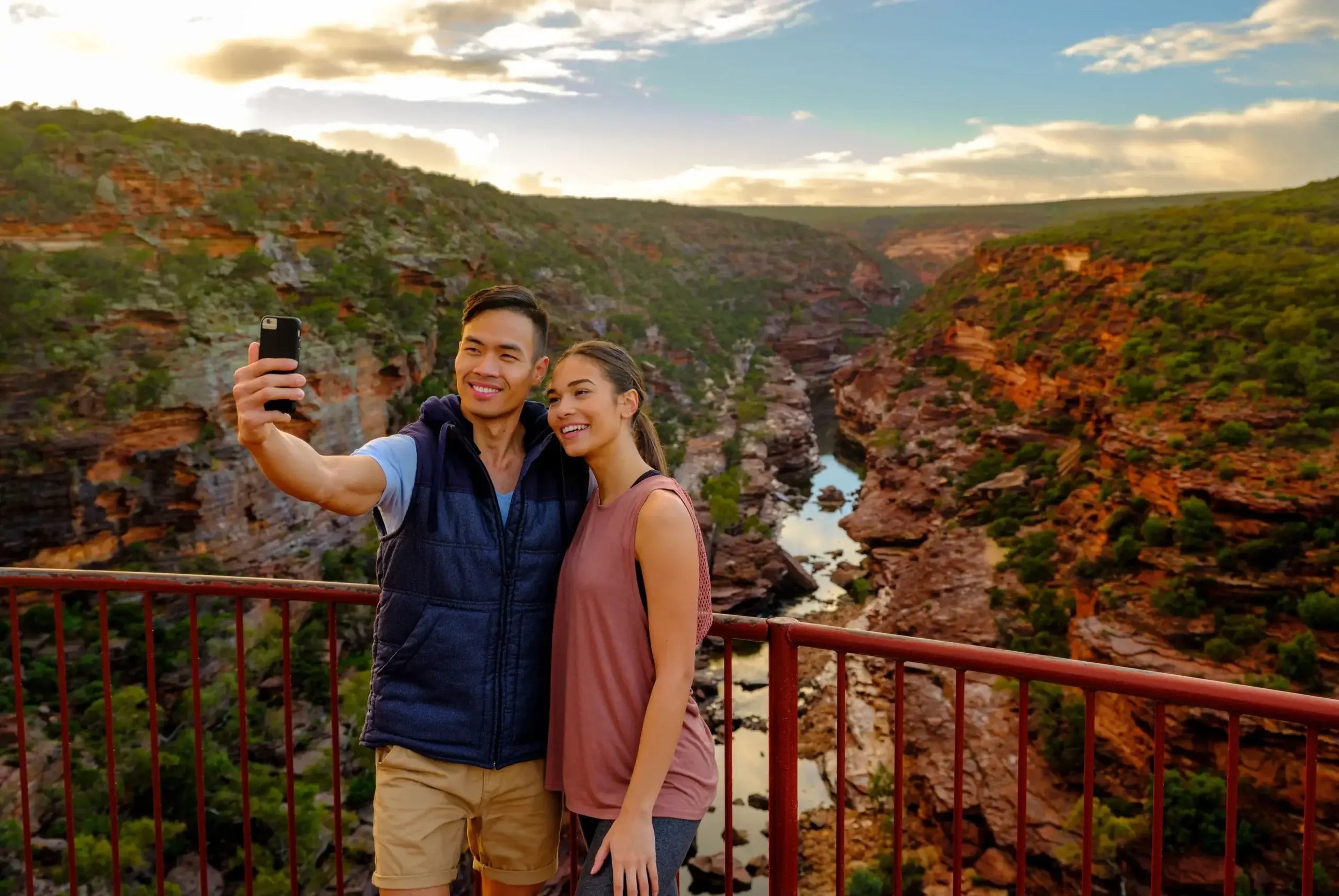 Couple taking selfie at Kalbarri Gorge lookout on West Coast Road Trip. Scenic hiking destination in Western Australia.