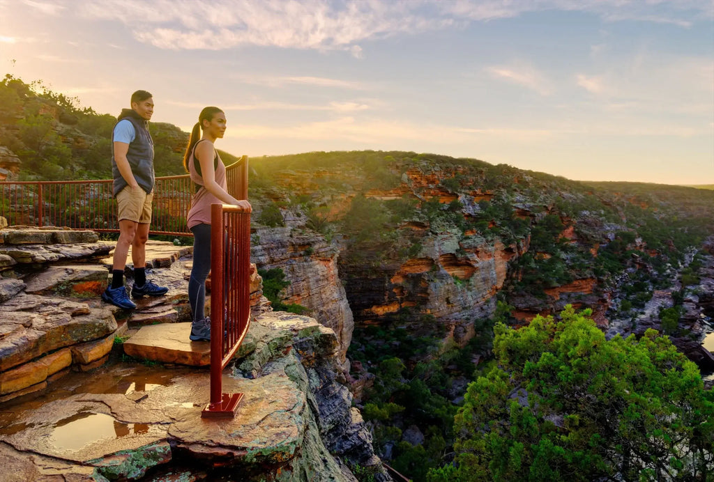 Couple enjoying scenic lookout over Kalbarri Gorge on West Coast Road Trip. Hiking and sightseeing in Western Australia’s national parks.
