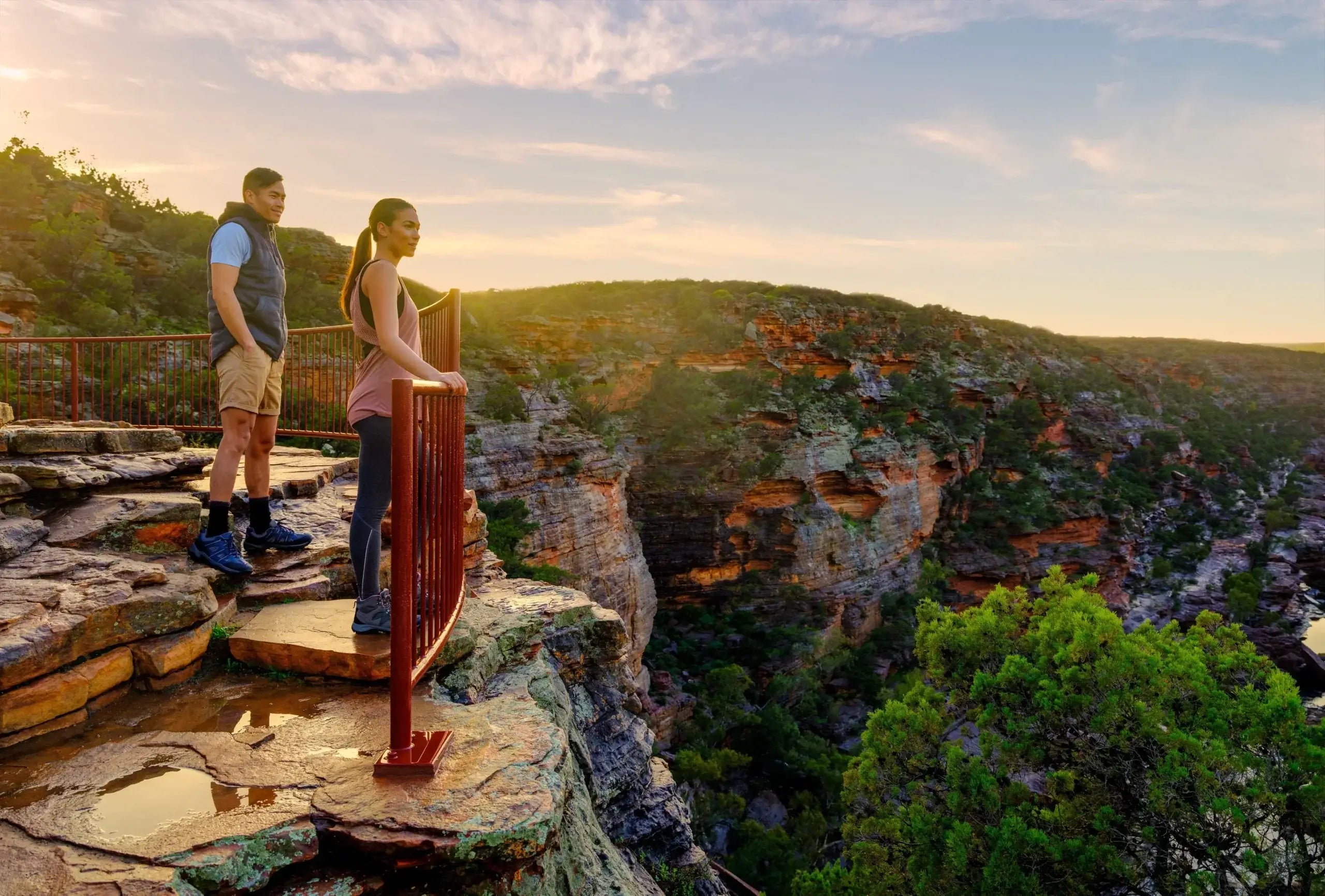Couple enjoying scenic lookout over Kalbarri Gorge on West Coast Road Trip. Hiking and sightseeing in Western Australia’s national parks.
